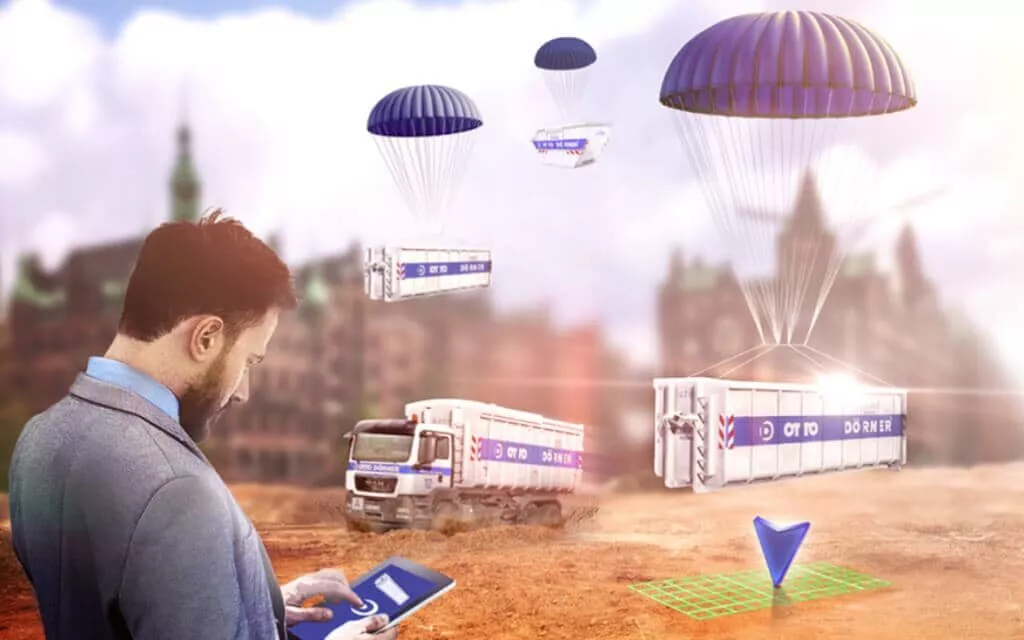 Mann steuert Lieferungen per Drohnen und Lkw in urbaner Umgebung mit Smartphone.